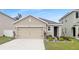 Charming single-Gathering home featuring a two-car garage and well-maintained front lawn at 10956 Carlton Fields Dr, Riverview, FL 33579
