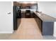 Open concept kitchen with dark cabinets, stainless steel appliances, and ample countertop space at 10956 Carlton Fields Dr, Riverview, FL 33579