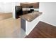A modern kitchen features granite countertops, wood cabinets, and stainless-steel appliances at 10956 Carlton Fields Dr, Riverview, FL 33579