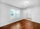 Cozy living room with wood floors, a large window with blinds, and a bright front entrance at 10956 Carlton Fields Dr, Riverview, FL 33579