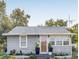 Charming one-story home featuring a gray exterior and a well-maintained front yard at 1426 Erie S St, St Petersburg, FL 33712