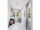 Bright sun room with many windows dressed with decorative curtains and tile flooring at 1426 Erie S St, St Petersburg, FL 33712