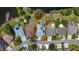 Aerial view of a single Gathering home with a pool and a well-manicured lawn, surrounded by lush greenery and a pond at 1913 Blue River Rd, Holiday, FL 34691