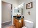 Bathroom with a wooden vanity with a bronze vessel sink and a tiled floor at 1913 Blue River Rd, Holiday, FL 34691