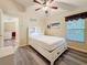 Comfortable bedroom featuring hardwood floors, a window, and ample natural light at 1913 Blue River Rd, Holiday, FL 34691
