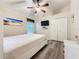 Cozy bedroom with hardwood floors, a window, and a ceiling fan at 1913 Blue River Rd, Holiday, FL 34691