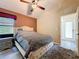 Bedroom featuring a plush rug, stylish furniture, neutral tones, and modern fixtures at 1913 Blue River Rd, Holiday, FL 34691