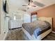 Cozy bedroom featuring a plush rug, modern furniture, neutral tones and a ceiling fan at 1913 Blue River Rd, Holiday, FL 34691