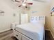 Inviting bedroom with hardwood floors, neutral paint, a ceiling fan and a closet at 1913 Blue River Rd, Holiday, FL 34691