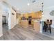 Spacious kitchen with breakfast bar and stainless steel appliances, plus gray wood-look floors at 1913 Blue River Rd, Holiday, FL 34691