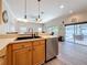 Kitchen with stainless steel dishwasher and sink, with access to the patio at 1913 Blue River Rd, Holiday, FL 34691