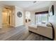 Open-concept living room with sliding glass doors to the pool, a sectional sofa, and wood-look flooring at 1913 Blue River Rd, Holiday, FL 34691