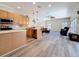 Open floor plan with kitchen and living area, wood-look floors and neutral paint colors at 1913 Blue River Rd, Holiday, FL 34691