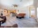 Open concept living area flowing into the kitchen with hardwood floors and neutral decor at 1913 Blue River Rd, Holiday, FL 34691
