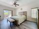 Spacious main bedroom featuring a king-sized bed and backyard patio access at 1913 Blue River Rd, Holiday, FL 34691