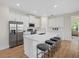 Spacious kitchen island with seating, stainless appliances and hardwood flooring, perfect for entertaining at 1486 Ardisia St, North Port, FL 34288