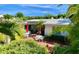 A charming backyard with red umbrellas, perfect for outdoor entertaining and relaxing at 16107 Gulf Blvd, Redington Beach, FL 33708