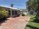Backyard with brick pavers, shed, landscaping and screened in porch at 16107 Gulf Blvd, Redington Beach, FL 33708