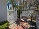 Backyard patio features brick pavers and privacy fencing with tropical landscaping at 16107 Gulf Blvd, Redington Beach, FL 33708