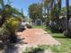 Backyard area features brick pavers, landscaping, and a storage shed at 16107 Gulf Blvd, Redington Beach, FL 33708