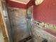 Bathroom featuring glass-enclosed shower and marble-look tile at 16107 Gulf Blvd, Redington Beach, FL 33708