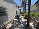 Side yard of home, showcasing tropical landscaping and exterior air conditioning unit at 16107 Gulf Blvd, Redington Beach, FL 33708
