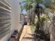 Side yard with brick pavers, tropical landscaping, and privacy fencing at 16107 Gulf Blvd, Redington Beach, FL 33708