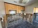 Kitchen undergoing renovation with wooden cabinets and black tile floor at 16107 Gulf Blvd, Redington Beach, FL 33708