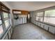 Living room with windows and tiled floor, ready for renovation and remodel at 16107 Gulf Blvd, Redington Beach, FL 33708