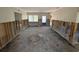 Living room undergoing renovation with natural light and exposed framing at 16107 Gulf Blvd, Redington Beach, FL 33708