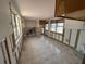 Spacious living room with multiple windows and tiled floor, ready for remodel at 16107 Gulf Blvd, Redington Beach, FL 33708
