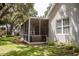 Exterior showcasing a screen porch and lush backyard landscape, providing a serene outdoor retreat at 2906 Country Breeze Dr, Plant City, FL 33567