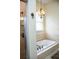 This bathroom features a tiled shower, a drop in tub, and neutral color tile throughout at 2906 Country Breeze Dr, Plant City, FL 33567