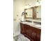 This bathroom features a double sink vanity with granite countertops and decorative gold trimmed mirrors at 2906 Country Breeze Dr, Plant City, FL 33567