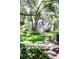 Detached garage surrounded by greenery, offering ample parking and additional storage space at 2906 Country Breeze Dr, Plant City, FL 33567