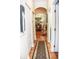 Hallway view to dining room, featuring hardwood floors, an area rug, and neutral wall colors at 2906 Country Breeze Dr, Plant City, FL 33567