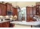 Kitchen showcasing granite countertops, stainless steel appliances, and dark wood cabinetry at 2906 Country Breeze Dr, Plant City, FL 33567