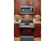 Modern kitchen featuring updated stainless steel stove and microwave at 2906 Country Breeze Dr, Plant City, FL 33567