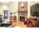 Bright living room with fireplace, stylish decor, and a view into the entry way at 2906 Country Breeze Dr, Plant City, FL 33567