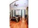 Bright living room featuring hardwood floors, ceiling fan, and large windows with curtains at 2906 Country Breeze Dr, Plant City, FL 33567