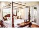 This main bedroom features a four poster bed, wood floors, and access to the porch through glass doors at 2906 Country Breeze Dr, Plant City, FL 33567
