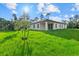 Large backyard offering green grass and a view of the home's rear exterior at 1240 Baywood Dr, North Port, FL 34288