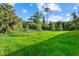 Expansive backyard offering a natural setting and abundant greenery at 1240 Baywood Dr, North Port, FL 34288