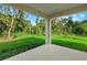 Covered patio area with views of a lush backyard and surrounding trees at 1240 Baywood Dr, North Port, FL 34288