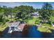 Expansive lakefront property with lush landscaping, a private dock, and boat house at 18620 Wayne Rd, Odessa, FL 33556
