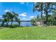 Lush backyard extending to a tranquil lake with mature trees offering shade at 18620 Wayne Rd, Odessa, FL 33556