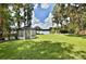 Lush backyard leading to a serene lake, featuring a charming gazebo and sitting area at 18620 Wayne Rd, Odessa, FL 33556