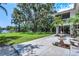 Backyard with lush greenery and mature trees extending to a lake with private dock at 18620 Wayne Rd, Odessa, FL 33556