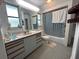 Well-lit bathroom featuring a large vanity and a shower-tub combination at 18620 Wayne Rd, Odessa, FL 33556