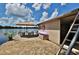Charming lake house exterior featuring a patio, outdoor seating, and serene waterfront views at 18620 Wayne Rd, Odessa, FL 33556